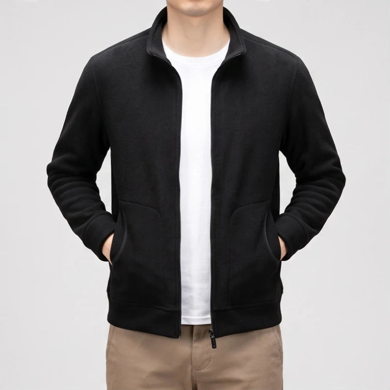 Black fleece jacket on an off-gray studio background