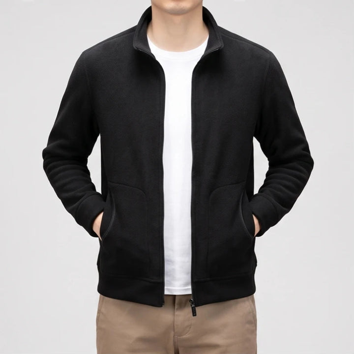 Black fleece jacket on an off-gray studio background