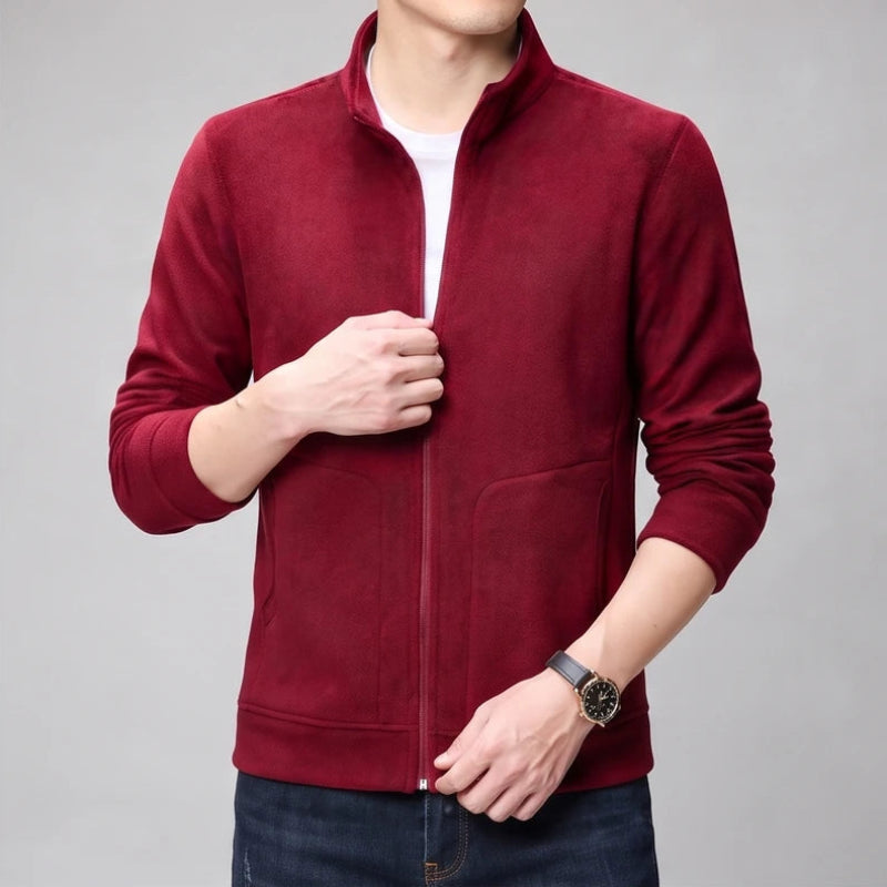 Burgundy fleece jacket on an off-gray studio background