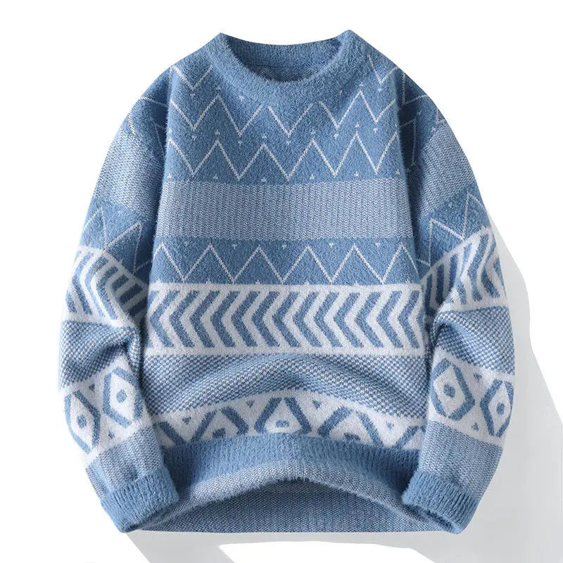 Light blue knit sweater with white geometric patterns, including chevron stripes, zigzags, and diamond shapes.