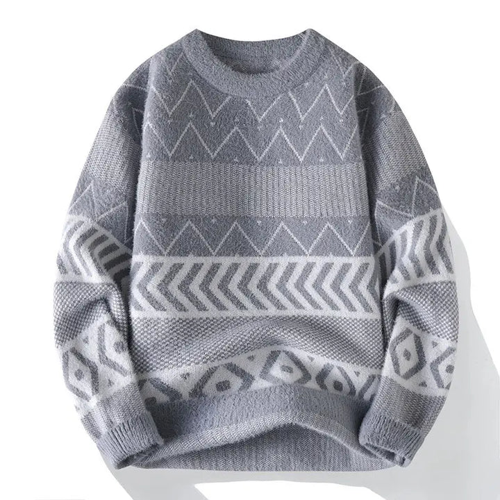 Flat lay of a soft gray knit sweater with a crew neck and white geometric patterns on the body and sleeves.