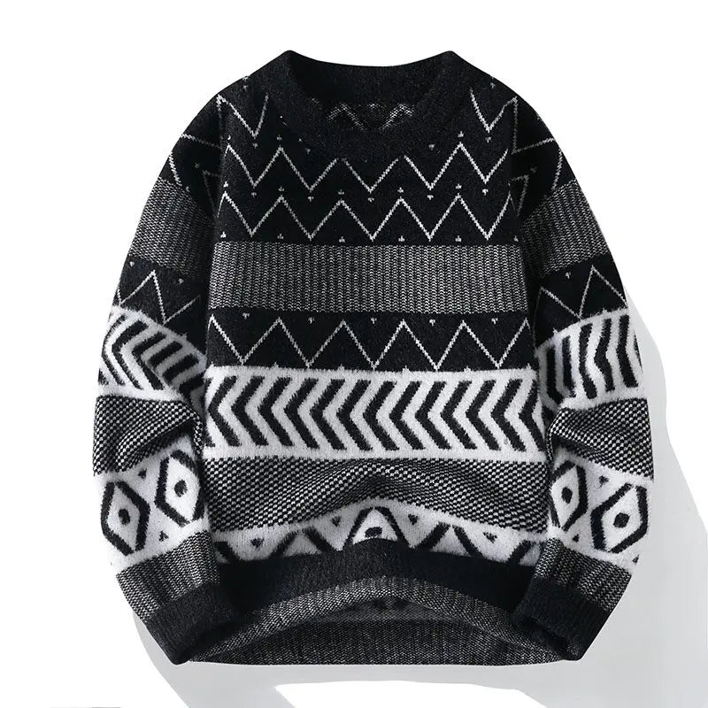 Flat lay of a black and white knit sweater featuring various geometric patterns including zigzags and chevrons.