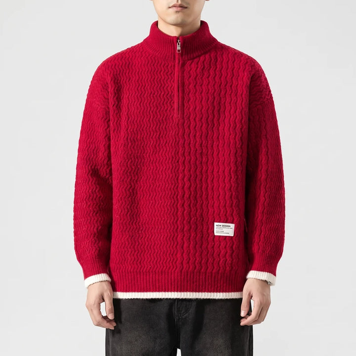 Man wearing a vibrant red half-zip sweater with a textured knit pattern and white cuffs, against a plain background.
