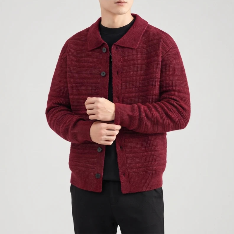 Man wearing a textured, dark red knit cardigan with a collar and black buttons, over a black shirt and pants.