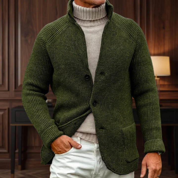 Green knit cardigan in a dark wood interior