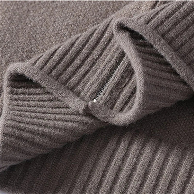 Close-up of a charcoal brown ribbed knit fabric with a visible zipper closure and soft, plush texture.