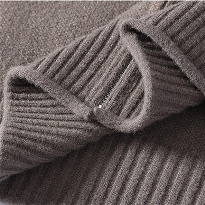 Close-up of a charcoal brown ribbed knit fabric with a visible zipper closure and soft, plush texture.