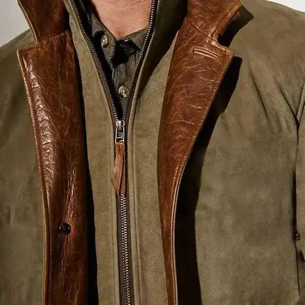 Close-up of a men's olive suede jacket with a brown distressed leather collar and a zippered inner placket.