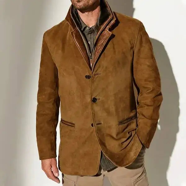 Man wearing a brown suede jacket with a brown leather collar and a three-button front closure, over a grey shirt.