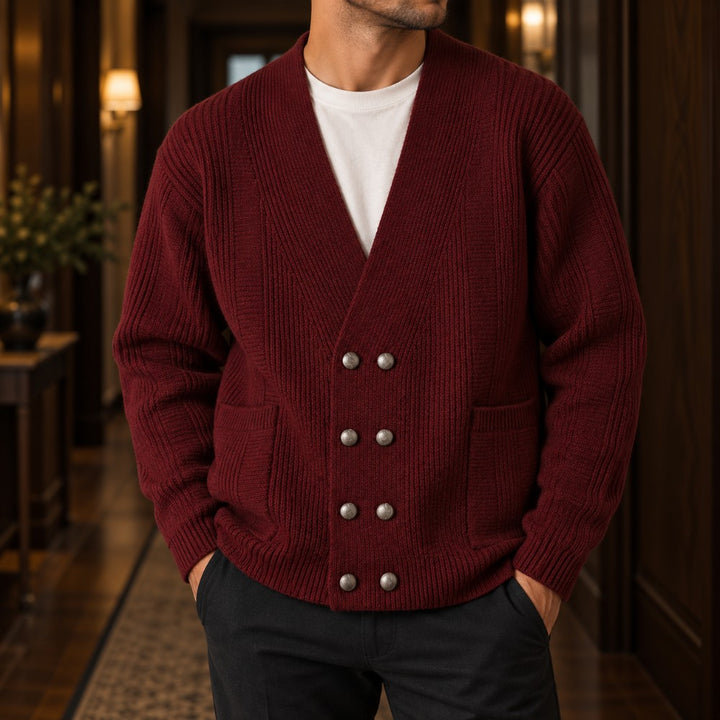 Man wearing a burgundy double-breasted ribbed knit cardigan with six silver buttons and two front pockets over a white tee.