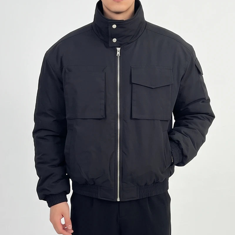 Black cotton jacket on an off-gray studio background