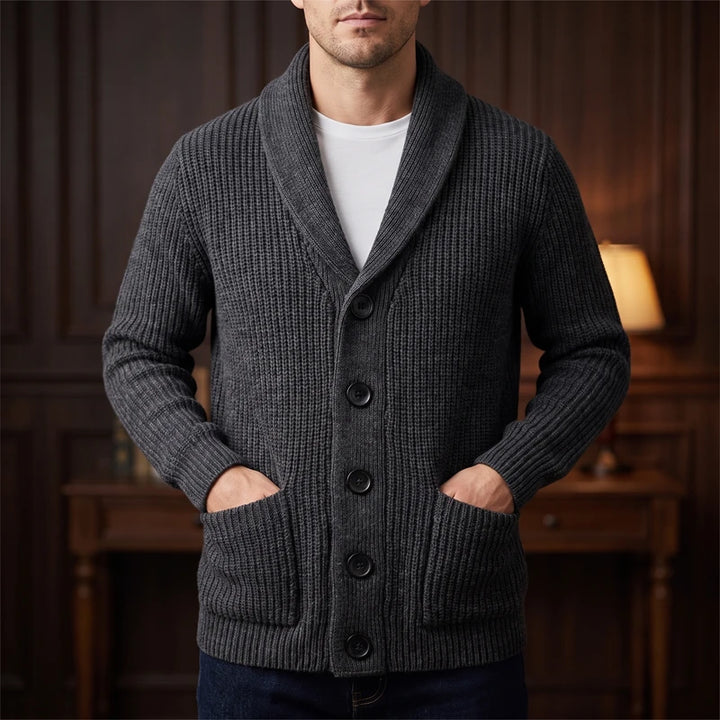 Gray knit cardigan in a dark wood interior