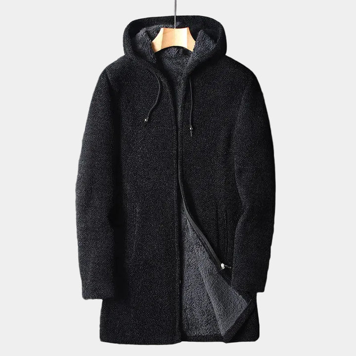 Black fleece coat with hood on a hanger against a light background