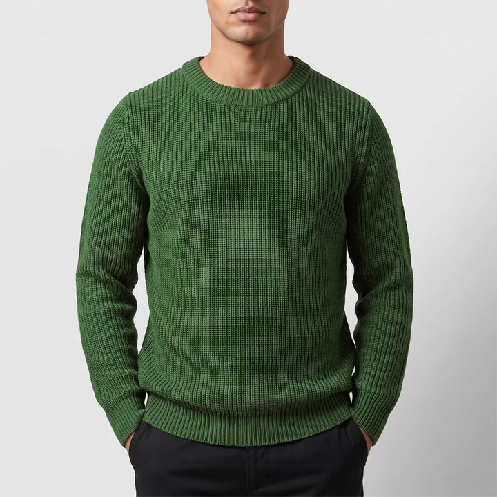 Model wearing army green knitted top in a studio