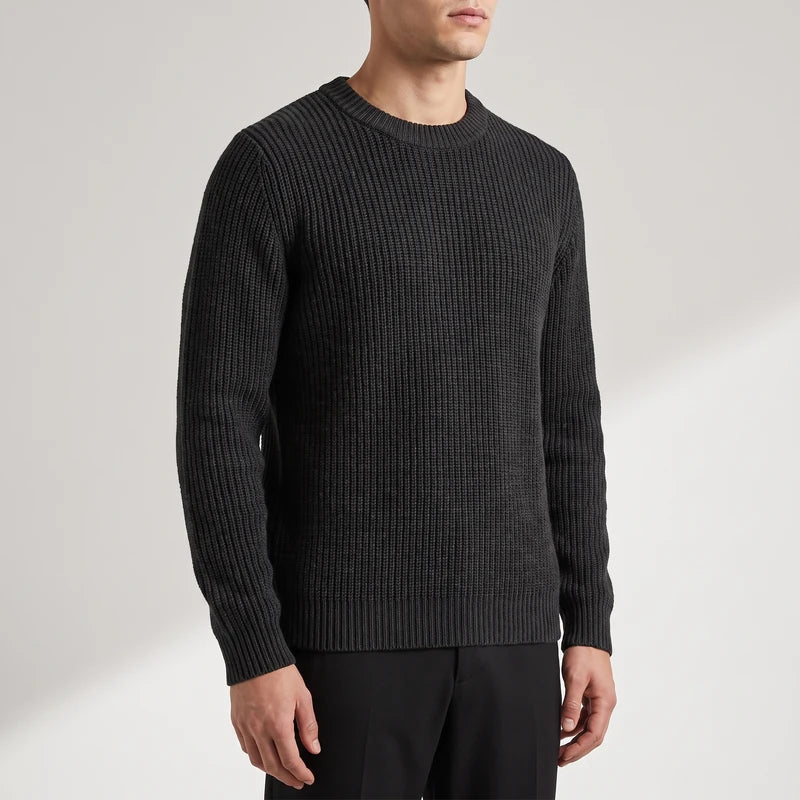 black knitted top on an off-gray studio background