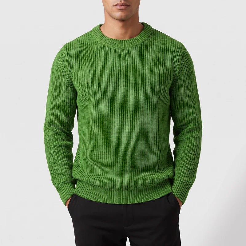 green knitted top on an off-gray studio background