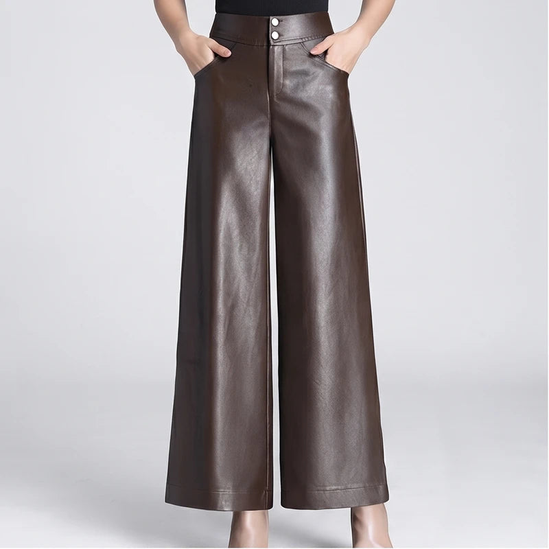 Brown leather pants on an off-gray studio background