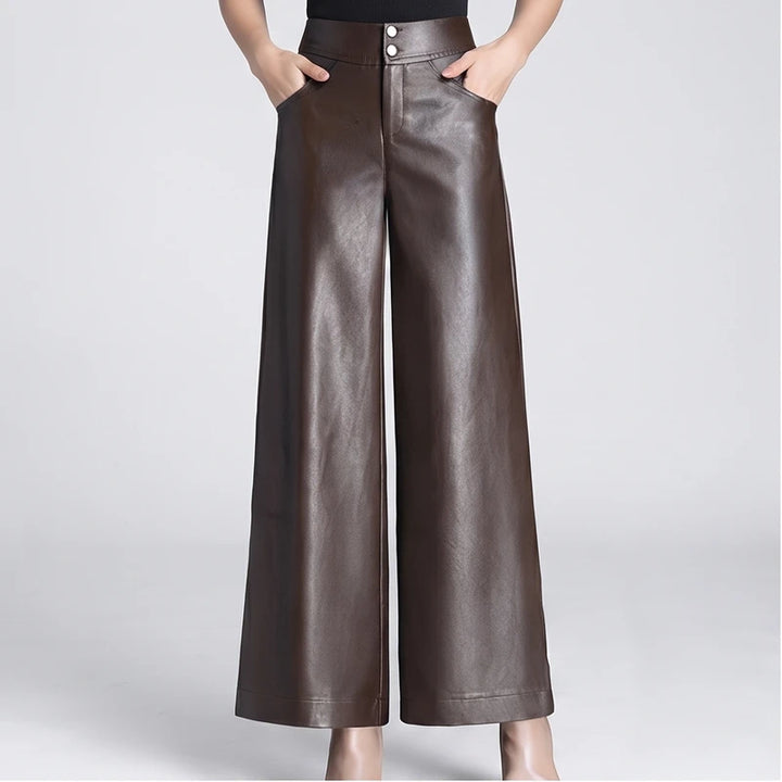 Brown leather pants on an off-gray studio background