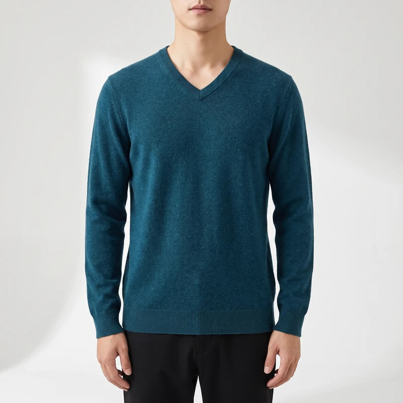 Teal knitted sweaters on an off-gray studio background