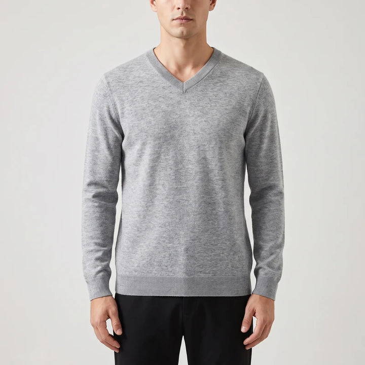 Medium gray knitted sweaters on an off-gray studio background