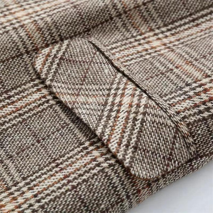 Close-up of a brown, beige, and rust plaid woven fabric with a detailed flap pocket.