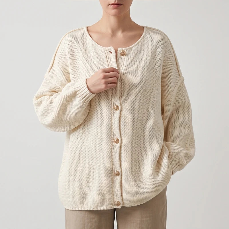 Beige knit cardigan on an off-gray studio background