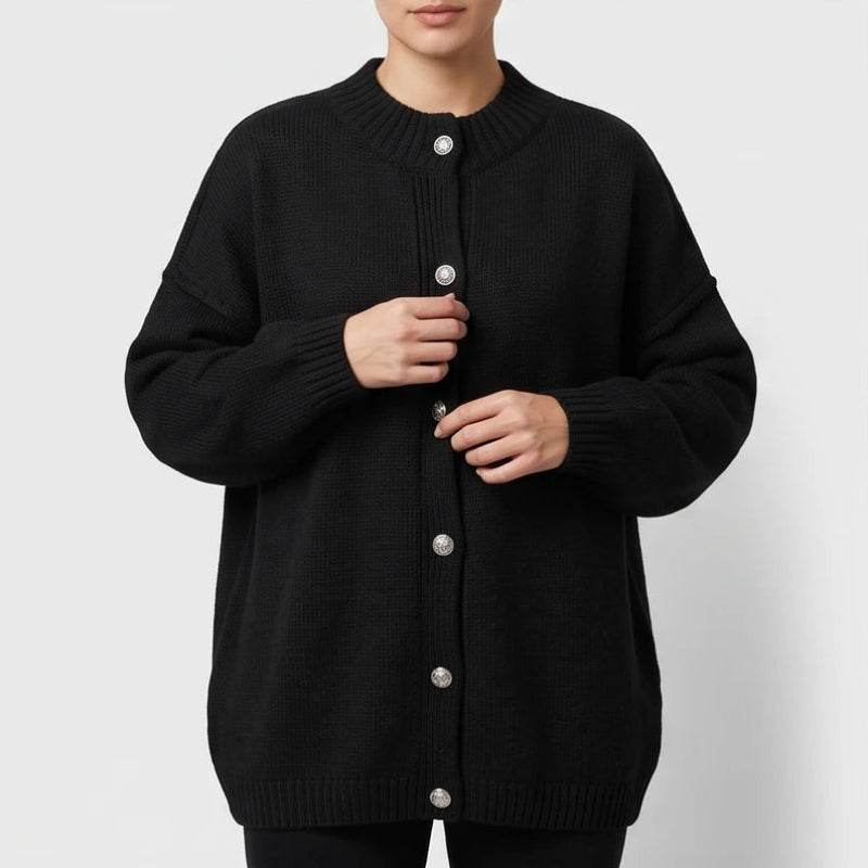 Black knit cardigan on an off-gray studio background