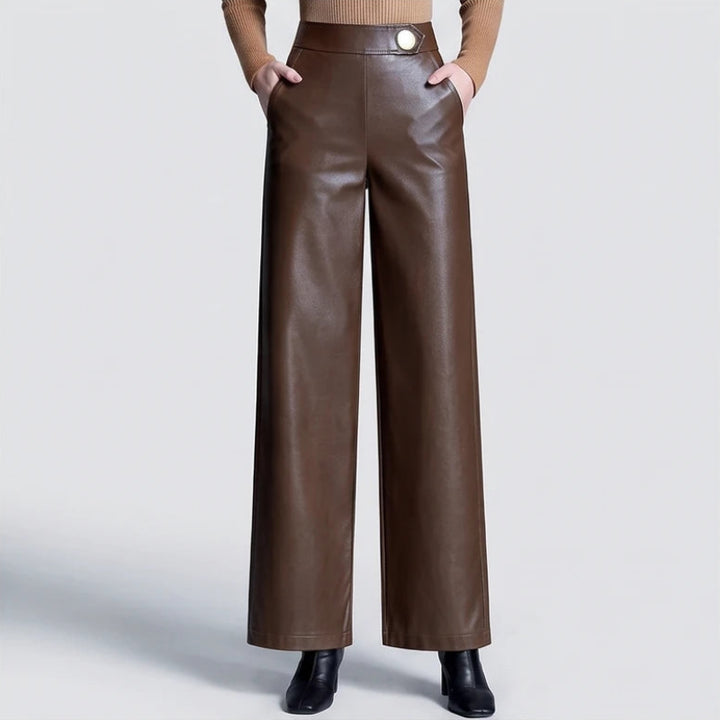 Coffee leather pants on an off-gray studio background