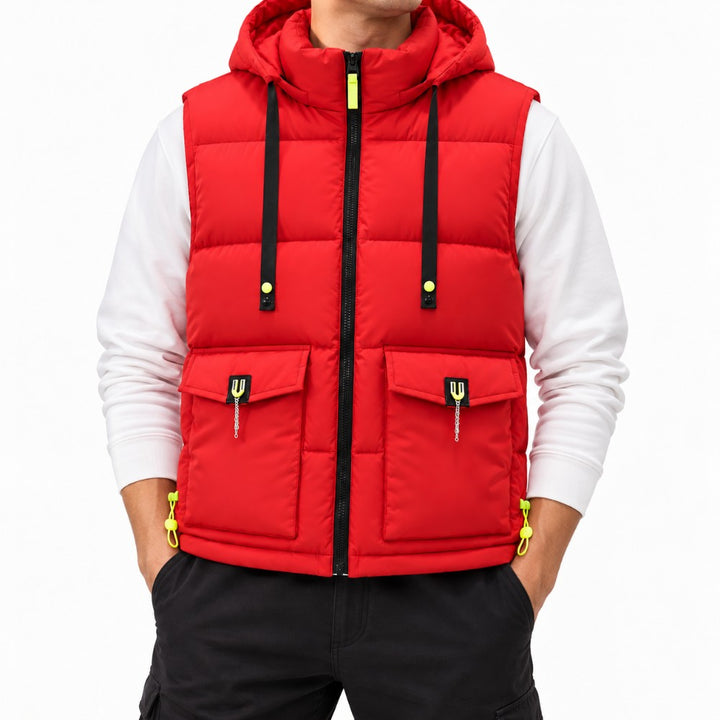 Man wearing a bright red hooded puffer vest with black zippers, neon yellow accents, and two prominent flap pockets.