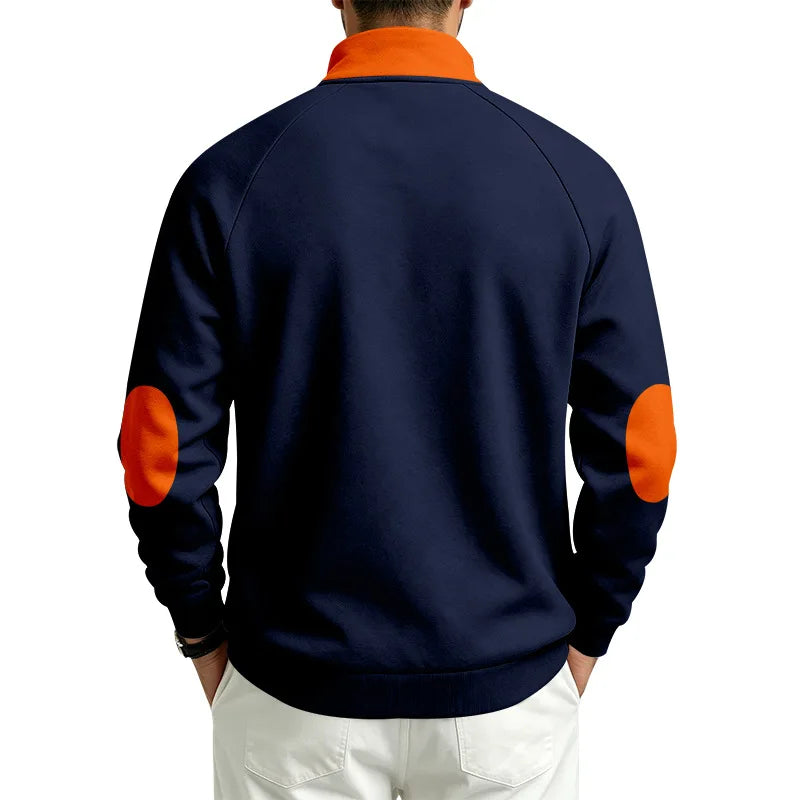 Man wearing a navy quarter-zip pullover with an orange collar and matching orange elbow patches, seen from the back.