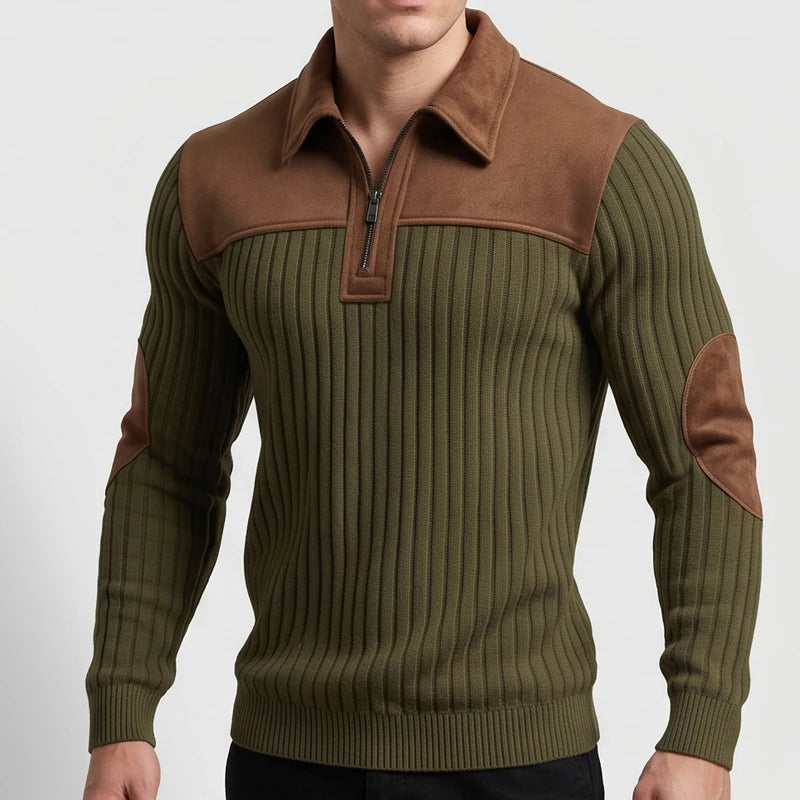 Man wearing an olive green ribbed quarter-zip sweater with a brown suede collar, yoke, and elbow patches.