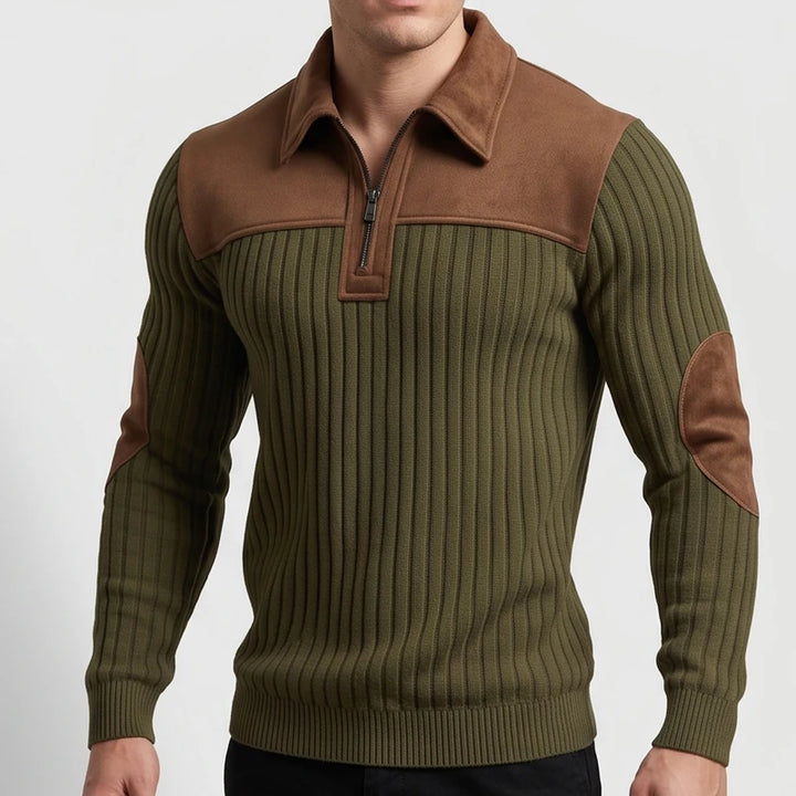 Man wearing an olive green ribbed quarter-zip sweater with a brown suede collar, yoke, and elbow patches.