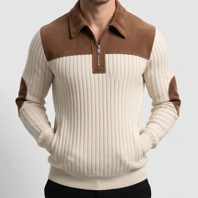 Man wearing a cream ribbed knit quarter-zip sweater with brown suede collar, shoulder yoke, and elbow patches.