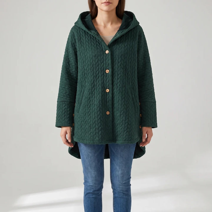 Green jacket on an off-gray studio background