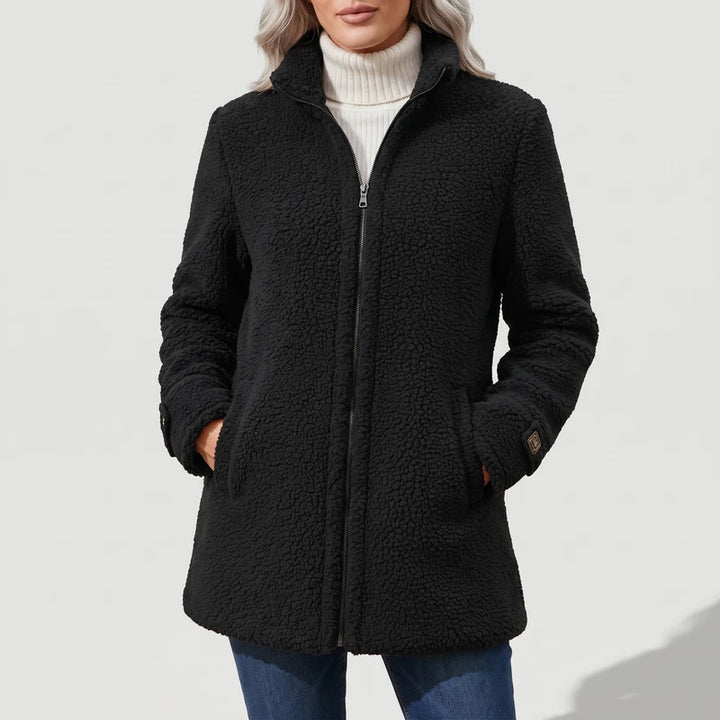 Black coat on an off-gray studio background