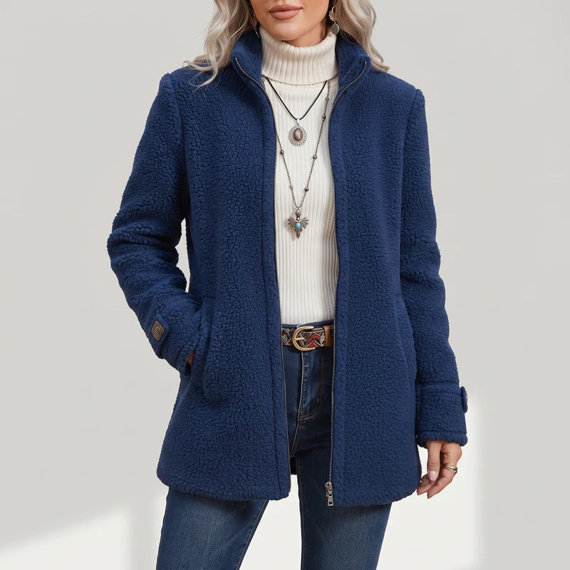 Blue coat on an off-gray studio background