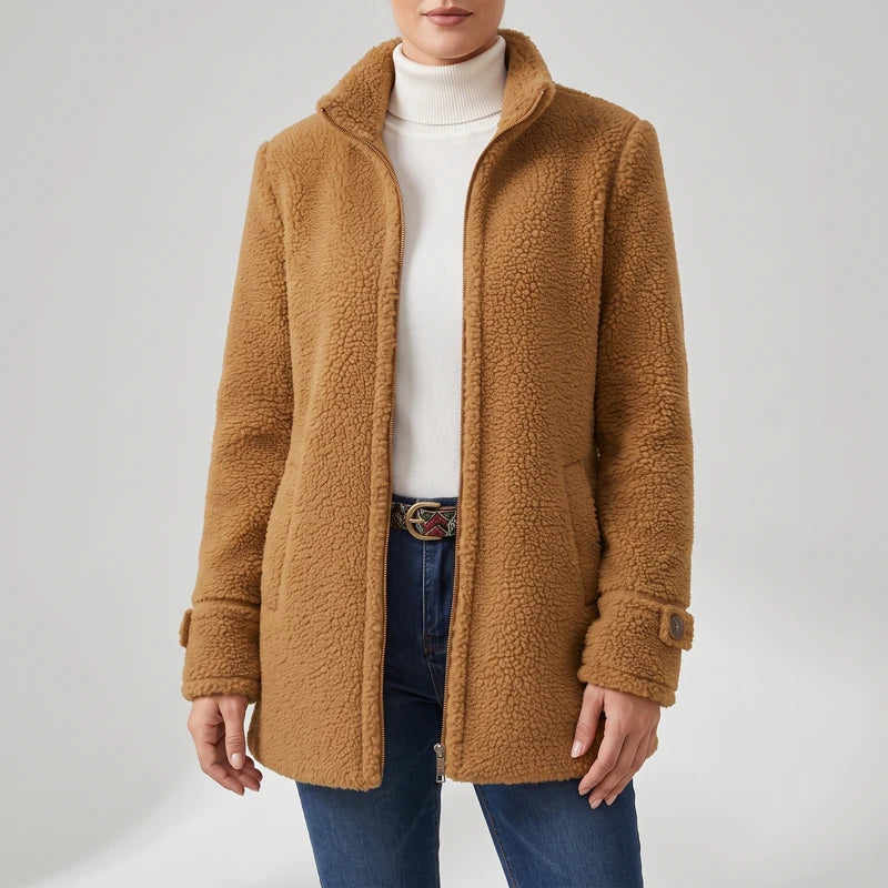 Camel coat on an off-gray studio background