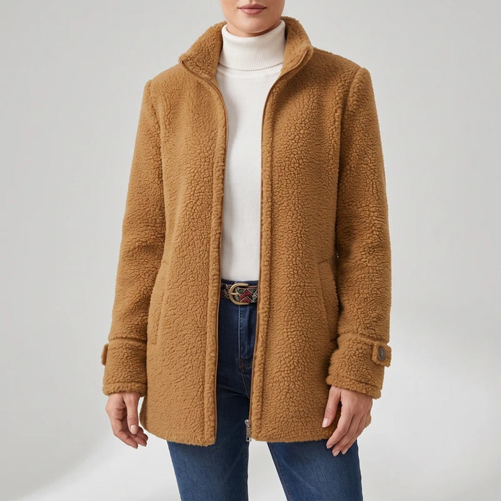 Camel coat on an off-gray studio background