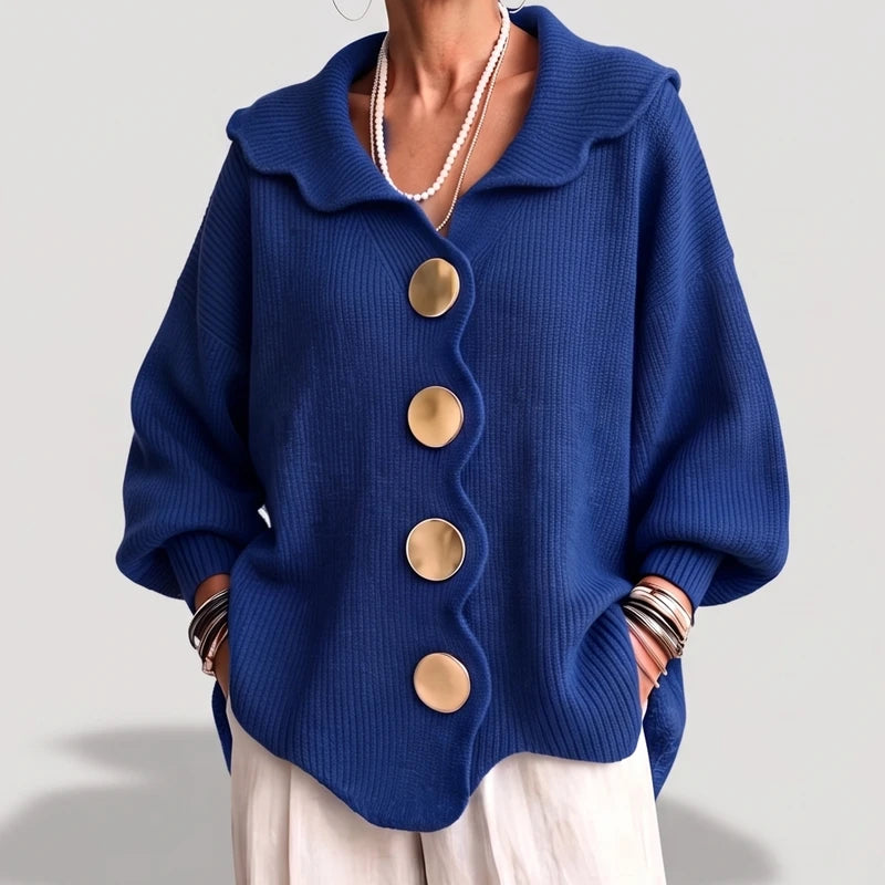 Blue knit cardigan on an off-gray studio background