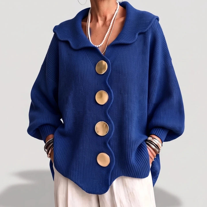 Blue knit cardigan on an off-gray studio background