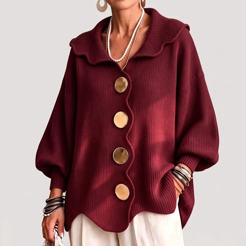 Red knit cardigan on an off-gray studio background