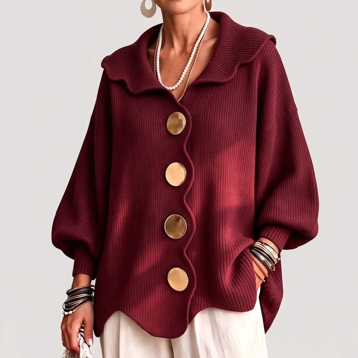 Red knit cardigan on an off-gray studio background
