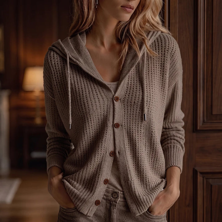 Khaki knit cardigan in a dark wood interior