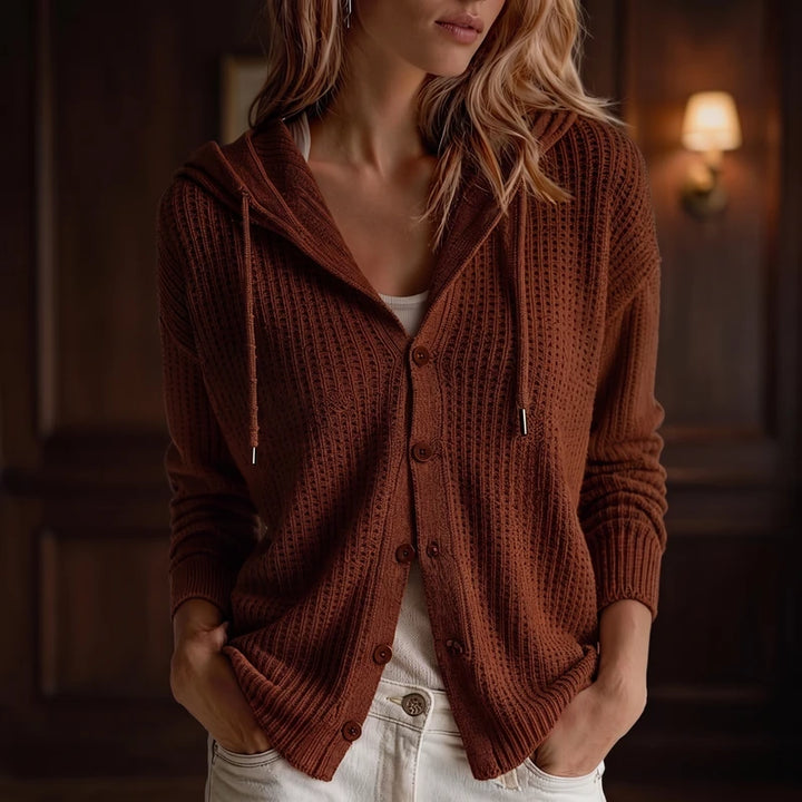 Maroon knit cardigan in a dark wood interior