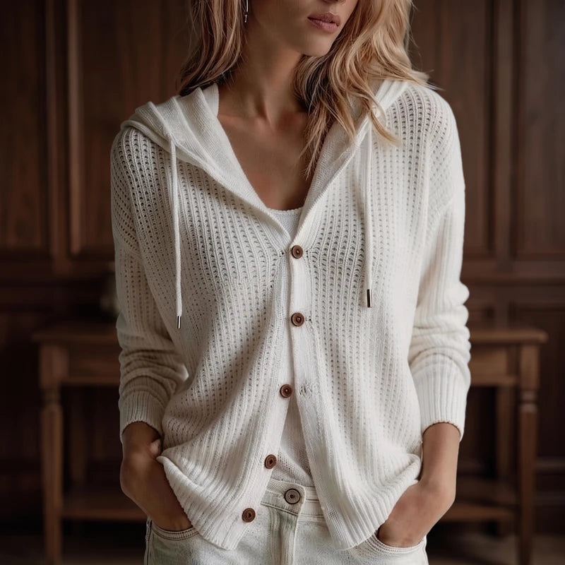 White knit cardigan in a dark wood interior