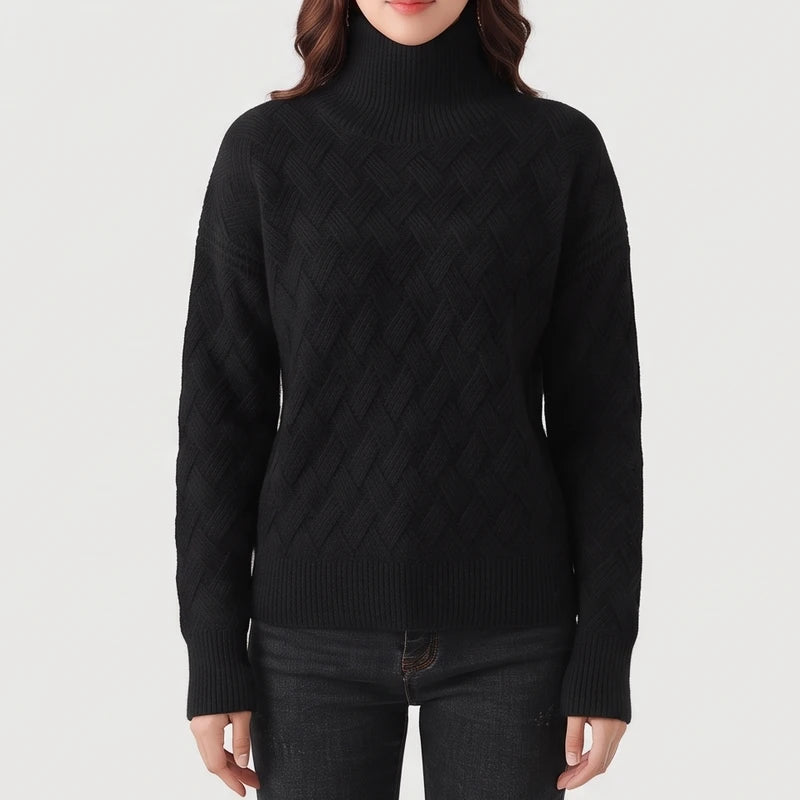 Woman wearing a black textured knit turtleneck sweater with ribbed cuffs and hem, paired with dark denim jeans.