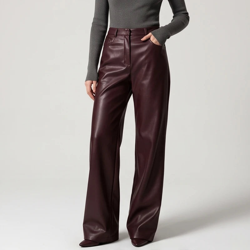 Brown leather pants on an off-gray studio background