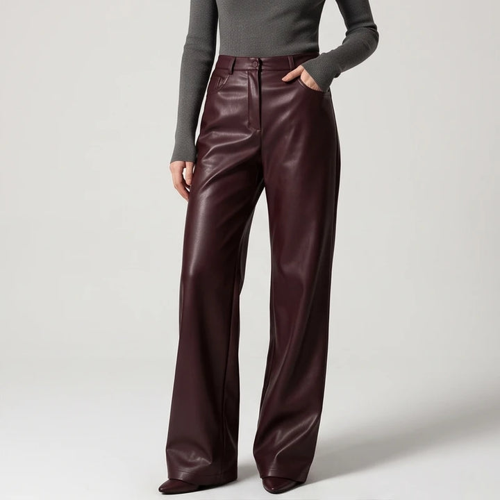 Brown leather pants on an off-gray studio background