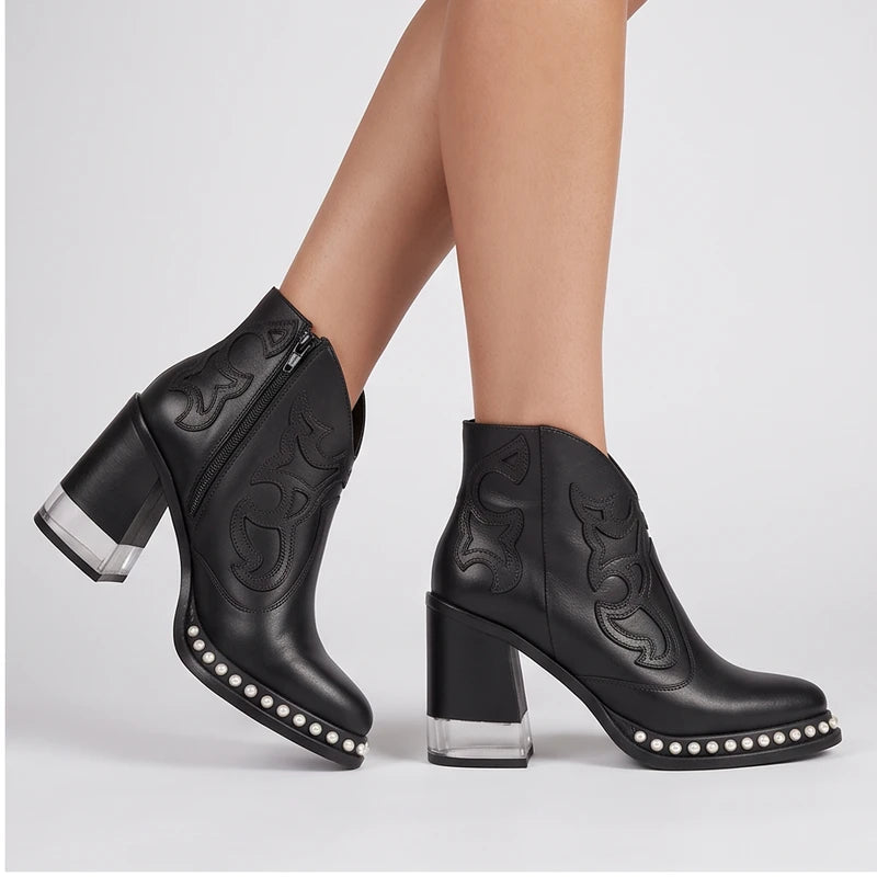 Model wearing Black leather boots in a studio