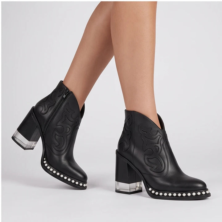Model wearing Black leather boots in a studio - 2